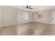 Bright living room featuring tile floors, a ceiling fan, and large windows at 2233 N Middlecoff Dr, Mesa, AZ 85215