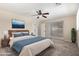 Relaxing main bedroom with ceiling fan, ensuite bathroom, and private patio access at 2233 N Middlecoff Dr, Mesa, AZ 85215