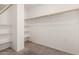 Walk-in closet featuring carpeted flooring and built-in shelves for ample storage space at 2233 N Middlecoff Dr, Mesa, AZ 85215
