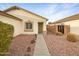 Home's exterior features a walkway and desert landscaping at 22574 W Mohave St, Buckeye, AZ 85326