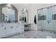 Spa-like bathroom with double vanity, walk-in shower, and glass block windows at 23807 N 64Th Ave, Glendale, AZ 85310