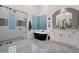Elegant bathroom features a soaking tub, walk-in shower, and stylish tilework at 23807 N 64Th Ave, Glendale, AZ 85310