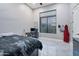 Spacious bedroom with a bed, desk, and large window at 23807 N 64Th Ave, Glendale, AZ 85310
