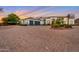 Elegant home exterior with a large driveway and landscaping at 23807 N 64Th Ave, Glendale, AZ 85310