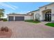 Home exterior with a three-car garage and attractive landscaping at 23807 N 64Th Ave, Glendale, AZ 85310
