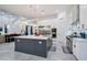 Modern kitchen features a large island, stainless steel appliances, and white cabinetry at 23807 N 64Th Ave, Glendale, AZ 85310