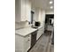 Modern kitchen with white cabinets and quartz countertops at 23807 N 64Th Ave, Glendale, AZ 85310