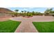 Landscaped backyard with a circular driveway and walkway at 23807 N 64Th Ave, Glendale, AZ 85310
