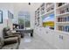 Home office with built-in shelving, large TV, and comfortable seating at 23807 N 64Th Ave, Glendale, AZ 85310