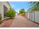 Side yard with a storage shed and paved pathway at 23807 N 64Th Ave, Glendale, AZ 85310