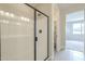 Modern bathroom featuring a glass enclosed shower and tile flooring at 24177 W Hilton Ave, Buckeye, AZ 85326