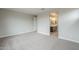 Bright bedroom with carpet, view of bathroom and doorway at 24177 W Hilton Ave, Buckeye, AZ 85326