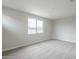Spacious bedroom with plush carpeting and a large window at 24177 W Hilton Ave, Buckeye, AZ 85326