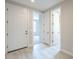 Bright entryway with multiple doors and wood-look flooring at 24177 W Hilton Ave, Buckeye, AZ 85326