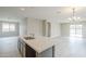 Open concept kitchen with a large island and a seamless flow into the living area at 24177 W Hilton Ave, Buckeye, AZ 85326