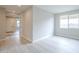 Inviting living room with light wood-look flooring and a bright window at 24177 W Hilton Ave, Buckeye, AZ 85326