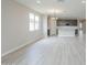 Bright living room showcasing neutral walls, wood-look floors, and recessed lighting at 24177 W Hilton Ave, Buckeye, AZ 85326