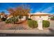 Single-story home with desert landscaping and a two-car garage at 26402 S Howard Dr, Sun Lakes, AZ 85248