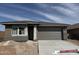 Charming single-story home showcasing a clean design, fresh driveway, and an inviting two-car garage at 31277 N 130Th Ave, Peoria, AZ 85383