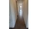 Bright hallway featuring hard surface floors and white walls that leads to the front entry way at 31277 N 130Th Ave, Peoria, AZ 85383