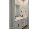 Modern bathroom with double sink vanity, quartz countertops, and dark hardware at 31363 N 130Th Ave, Peoria, AZ 85383