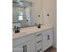 Modern bathroom with double sink vanity, quartz countertops, and dark hardware at 31363 N 130Th Ave, Peoria, AZ 85383