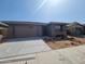 Charming single-story home featuring stone accents, a two-car garage, and desert landscaping at 31363 N 130Th Ave, Peoria, AZ 85383