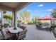 Spacious backyard patio with seating area, dining table, and fire pit at 3525 E Robin Ln, Phoenix, AZ 85050