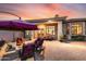 Evening view of backyard patio with seating area and fire pit at 3525 E Robin Ln, Phoenix, AZ 85050