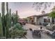 Spacious backyard patio with seating area, fire pit, and desert landscaping at 3525 E Robin Ln, Phoenix, AZ 85050