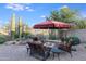 Patio with fire pit, seating area, and umbrella for shade at 3525 E Robin Ln, Phoenix, AZ 85050