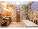 Elegant bathroom with soaking tub, double vanity, and decorative tile at 3525 E Robin Ln, Phoenix, AZ 85050