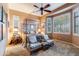 Spacious bedroom with a four-poster bed, ceiling fan, and ample natural light at 3525 E Robin Ln, Phoenix, AZ 85050