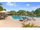 Resort-style community pool with lounge chairs and umbrellas at 3525 E Robin Ln, Phoenix, AZ 85050