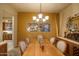 Charming dining room with wood table and access to kitchen at 3525 E Robin Ln, Phoenix, AZ 85050
