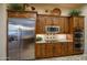 Well-equipped kitchen features stainless steel appliances and rich wood cabinetry at 3525 E Robin Ln, Phoenix, AZ 85050
