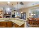 Open kitchen with granite island, breakfast nook, and access to backyard at 3525 E Robin Ln, Phoenix, AZ 85050