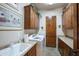 Laundry room with wooden cabinets, a sink, and washer/dryer hookups at 3525 E Robin Ln, Phoenix, AZ 85050