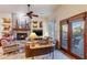 Cozy living room with stone fireplace, built-ins, and access to backyard at 3525 E Robin Ln, Phoenix, AZ 85050