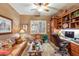 Home office with built-in shelving and a comfortable seating area at 3525 E Robin Ln, Phoenix, AZ 85050