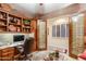 Bright home office with built-in wooden desk and cabinets at 3525 E Robin Ln, Phoenix, AZ 85050