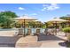 Resort-style pool with lounge chairs and umbrellas at 3525 E Robin Ln, Phoenix, AZ 85050