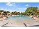 Community pool with a shallow end and plenty of lounge chairs at 3525 E Robin Ln, Phoenix, AZ 85050