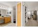 Bathroom with granite countertop, wood cabinets, and view of bedroom at 3825 E Camelback Rd # 290, Phoenix, AZ 85018