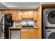 Modern kitchen with double sink and black appliances at 3825 E Camelback Rd # 290, Phoenix, AZ 85018