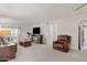 Living room with leather recliner, fireplace, and balcony access at 3825 E Camelback Rd # 290, Phoenix, AZ 85018