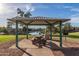 Relaxing gazebo with picnic table overlooking a lake, perfect for outdoor gatherings at 4077 S Sabrina Dr # 80, Chandler, AZ 85248