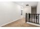 Upstairs hallway features neutral carpet and dark wood railings at 4077 S Sabrina Dr # 80, Chandler, AZ 85248