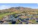 Aerial view of community with clubhouse, pool, and mountain backdrop at 42034 N Harbour Town Ct, Anthem, AZ 85086