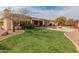 Artificial turf backyard with fire pit and patio at 42034 N Harbour Town Ct, Anthem, AZ 85086